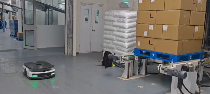 AMR moving pallets in warehouse facility